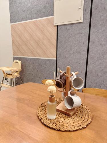 a table with a figurine on top of it at Cozy Beachfront Seaview with 2 CarParks FOC Netflix Access and YouTube Premium 3Beds3Bath 6-11pax by Minshuku in Johor Bahru