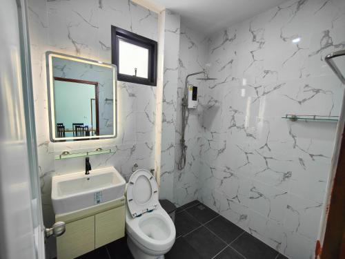 a bathroom with a toilet and a sink and a mirror at The Blue House Lipa Noi in Koh Samui 