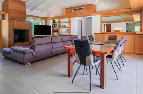 a living room with a couch and a table and chairs at Casa A Sapa in Bonifacio