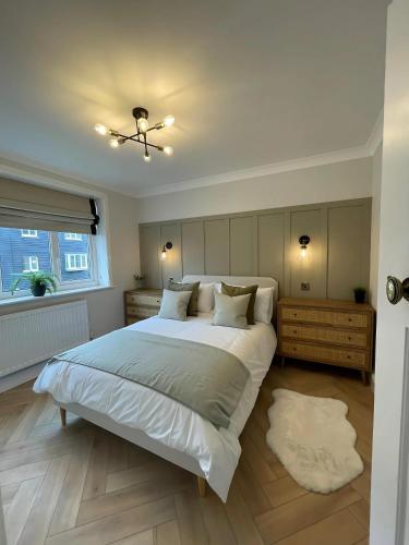 a bedroom with a large white bed and a window at Hidden Gem Whitstable in Whitstable