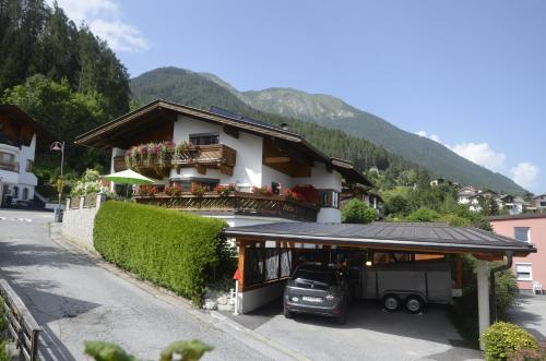 a building with a car parked in front of it at Ferienwohnung Möderndorfer, Fulpmes in Fulpmes