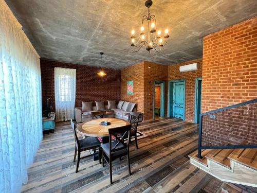 a living room with a table and a couch at Dad Residence in Lankaran