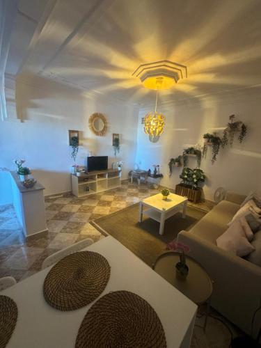 a living room with a couch and a table at Dar Saphire Apartments in Chefchaouene