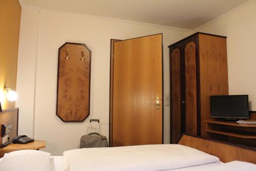a bedroom with a bed and a wooden door at Haus zur Waldbrücke in Marktheidenfeld