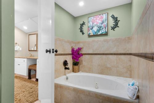 a bathroom with a tub and a sink at East Pass 308 in Destin