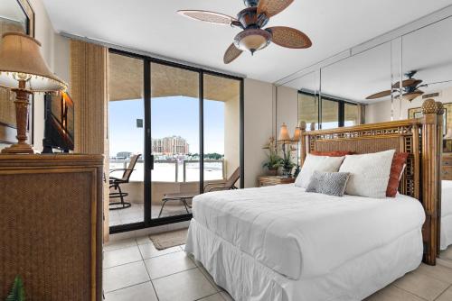 a bedroom with a bed and a balcony at East Pass 308 in Destin