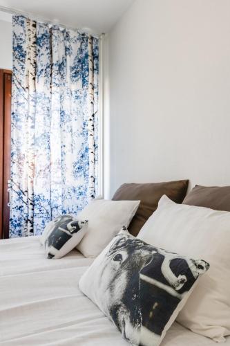 a bedroom with a bed with pillows and a window at Santa's Holiday Homes in Rovaniemi