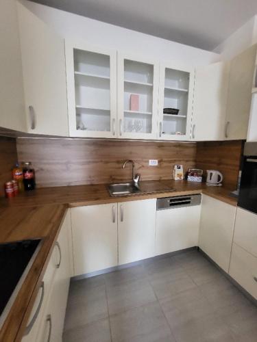 a kitchen with white cabinets and a sink at Apartman Janja in Čapljina