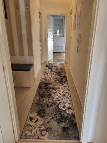 a hallway of a house with a rug on the floor at Apartman Janja in Čapljina