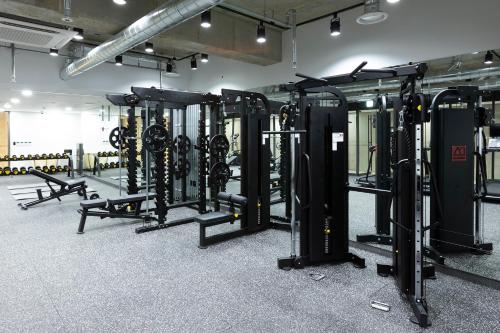 a gym with several rows of equipment in a room at Pangyo Business & Tourist Hotel KYND in Seongnam