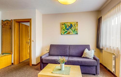 a living room with a purple couch and a table at Schoene Ferienwohnung in Kirchberg in Tirol