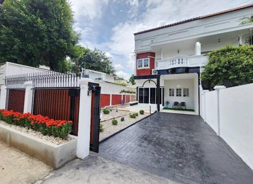 a driveway of a house with a red and white building at Boxsoon Nimman 2 # 4beds 3baths in Chiang Mai