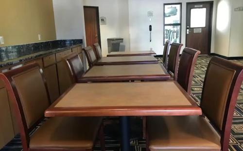 a row of tables and chairs in a restaurant at Blue Way Inn Eagan Extended Stay in Eagan
