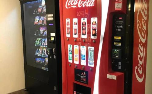 a cocacola vending machine next to a soda machine at Blue Way Inn Eagan Extended Stay in Eagan