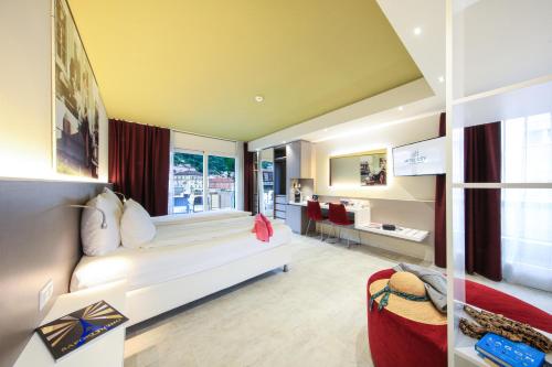 Postel nebo postele na pokoji v ubytování Hotel City Locarno