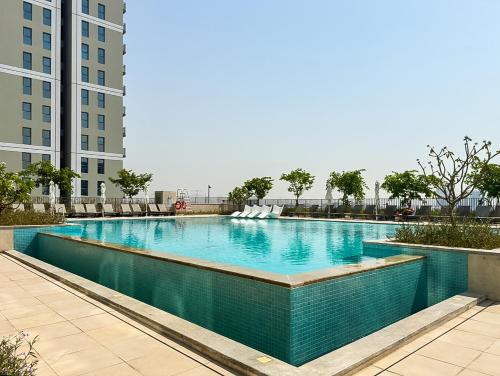 a swimming pool in the middle of a building at Socio Tower1 - Dubai Hills Modern Urban Retreat in the City by Serenity Living Holiday Homes in Dubai