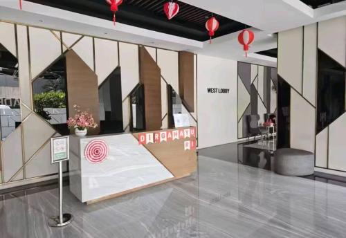 a lobby with a table with a red target on it at Green Sedayu Apartment Family Suite by Ellison in Jakarta