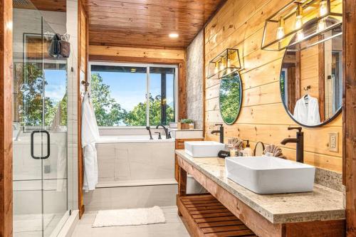 a bathroom with two sinks and a shower at Hot Tub Chalet Mountain Views & Holidays in Gatlinburg in Gatlinburg