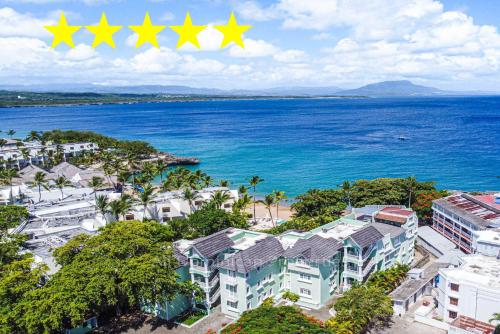 an aerial view of a resort with three stars at "Galeria Beach", Ocean front! in Sosúa