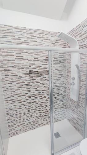 a shower with a glass enclosure in a bathroom at Sunset Suite - private pool and jacuzzi with oceanview in Adeje
