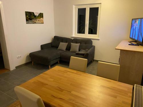 a living room with a couch and a table at Monteurwohnung in 94405 Landau an der Isar in Landau an der Isar