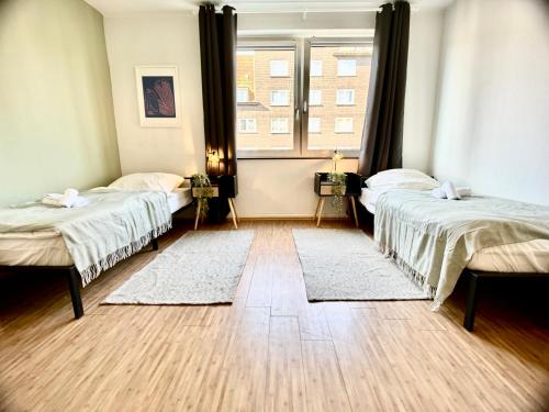 a room with two beds and a window at BLISS Homes GE RingCity in Gelsenkirchen