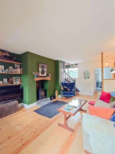 a living room with a couch and a table at Cosy Welsh Town Cottage in Brecon