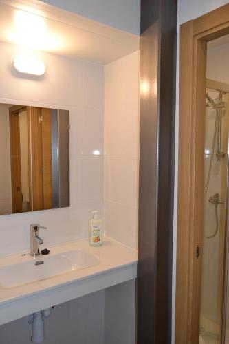 a bathroom with a sink and a mirror at Villa de Salas Alojamientos in Salas