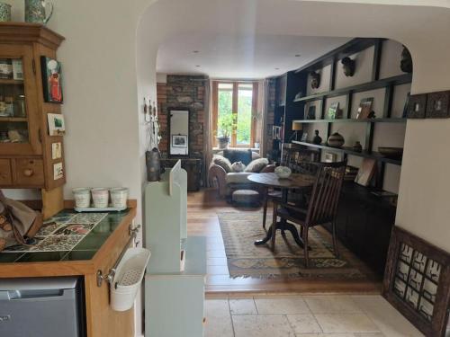 a kitchen with a table and a living room at Home in County Wicklow Unique Escape in Tinahely