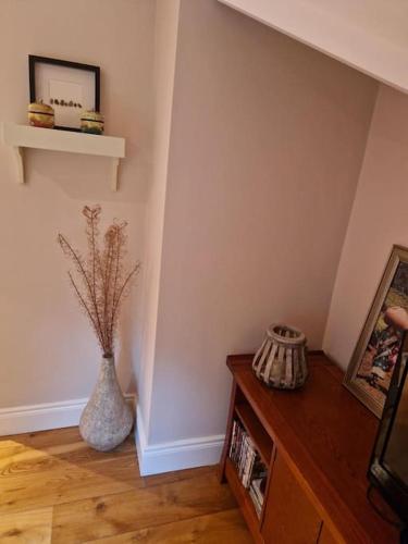 a room with a vase on the floor and a table at Home in County Wicklow Unique Escape in Tinahely