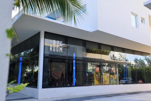 a store front of a building with glass windows at STUDIO apartment near Seven Mile Beach at The Grove in Upper Land