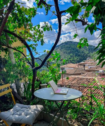 a table and chair with a book on a table at Nika's Guest House in Berat