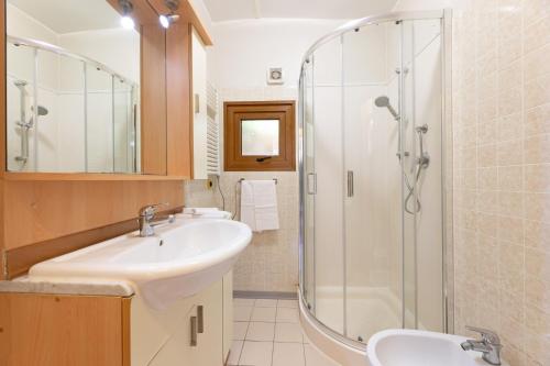 a bathroom with a sink and a shower at Camping Bungalow Lido in Capoliveri