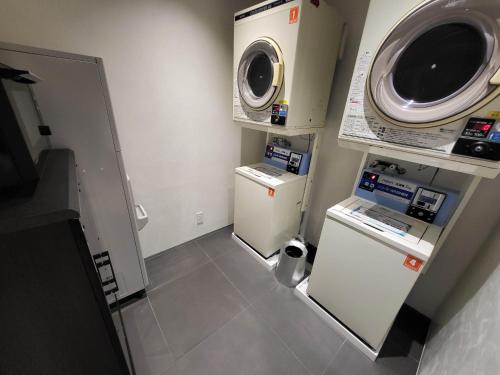 a small room with two refrigerators and a microwave at Hotel Royal Garden Kisarazu in Kisarazu