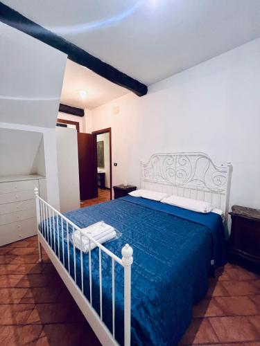 a bedroom with a bed with a blue comforter at CASA ALBY in Rapallo