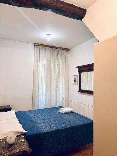a bedroom with a blue bed and a window at CASA ALBY in Rapallo