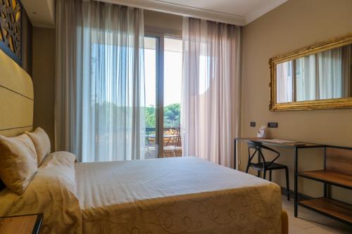 a bedroom with a bed and a window and a desk at Domus Aurelia in Rome