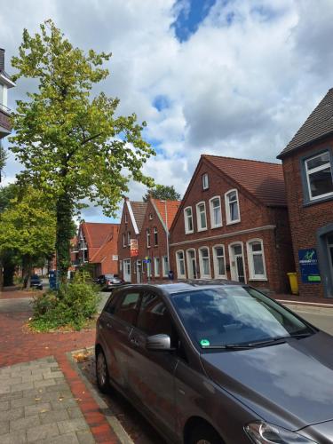 a car parked on a street in front of houses at Brigg in Emden