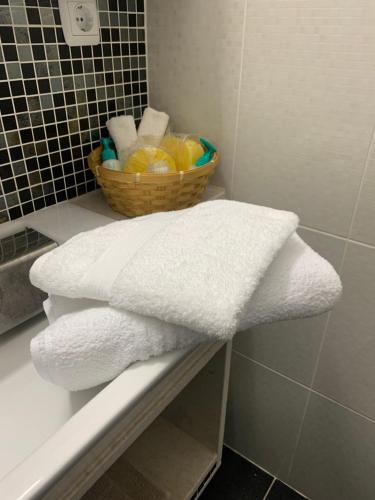 a basket of towels sitting on a shelf in a bathroom at Aria Apartment in Chalkida