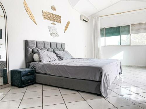 a bedroom with a large bed in a white room at Villa Anas in Sale
