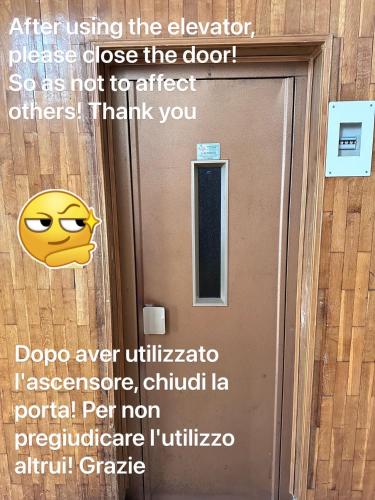a sign on a door with a cartoon face on it at Lisa HOUSE in Rome