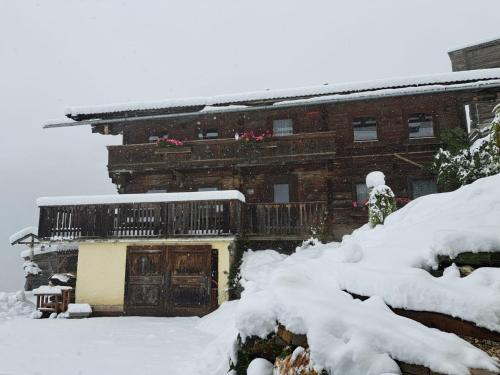a building covered in snow in front at Bauernhaus Viehhauser in Hüttschlag