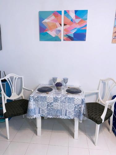 a table with a blue and white table cloth on it at Blue Diamond Staycation beside Enchanted Kingdom in Santa Rosa Laguna in Santa Rosa