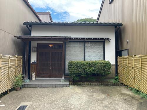 a house with a gate and a wooden door at 匠と昊 Naru Sora in Kaga