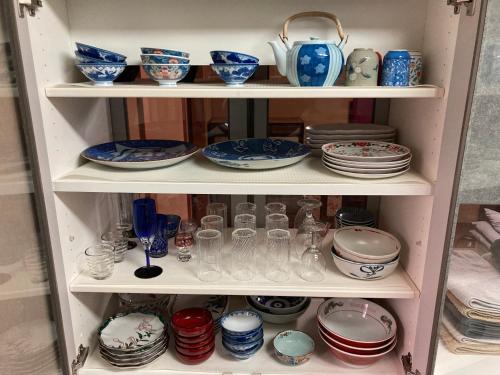 a shelf filled with plates and bowls and dishes at 匠と昊 Naru Sora in Kaga