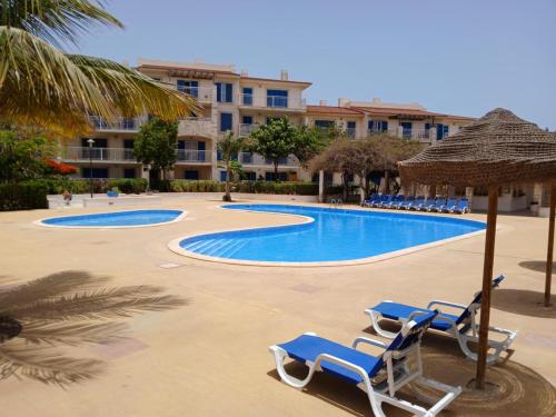 a pool with chairs and umbrellas in a resort at Holiday Home - Santa Maria in Prainha