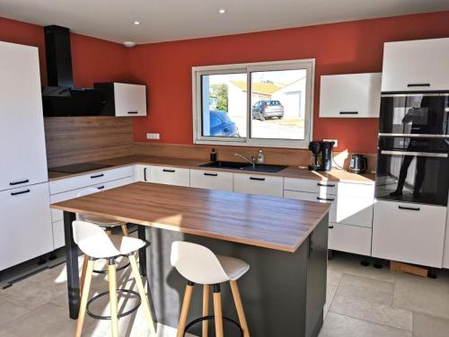 une cuisine avec des armoires blanches et un comptoir en bois dans l'établissement L'Ancrage- 800m de la plage, à Brem-sur-Mer