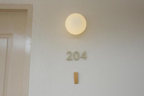 a door with a lit up number on a wall at Urban room samed in Ko Samed