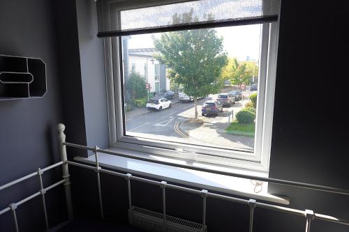 a window in a room with a view of a street at Luxury Rooms - Pick a Room - Free Parking & Kitchen Access, Near Etihad Stadium, The Coop Live & Piccadilly Station, Manchester in Manchester