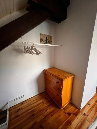 a room with a wooden dresser and a shelf at Gîte de la petite Reine in Champagney